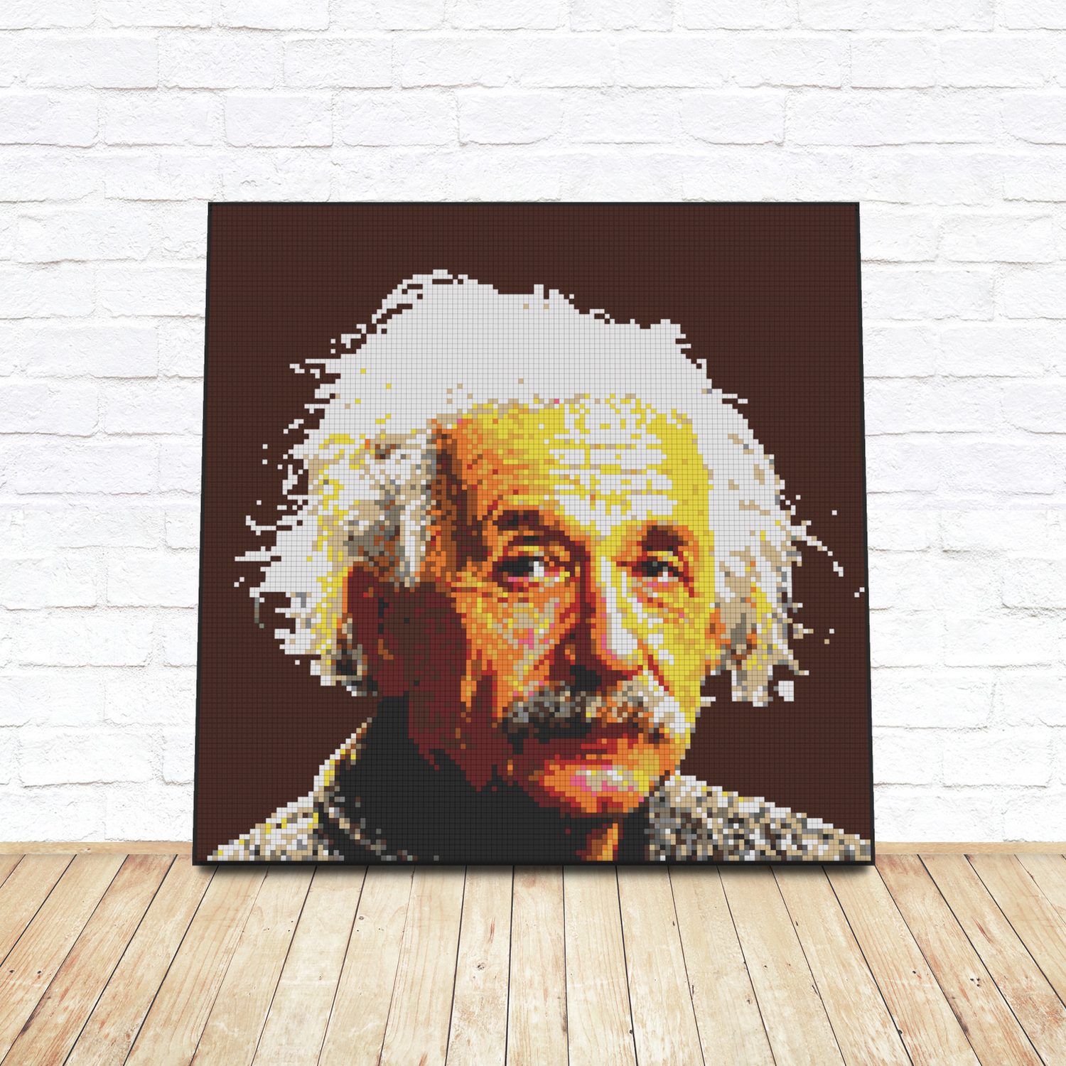 Framed LEGO tile pop-art portrait of Albert Einstein leaning against a white brick wall