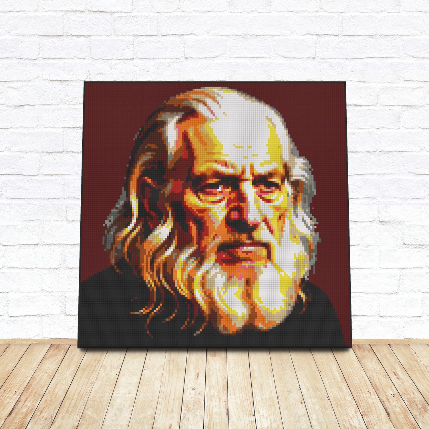 Framed LEGO tile pop-art portrait of Leonardo da Vinci leaning against a white brick wall