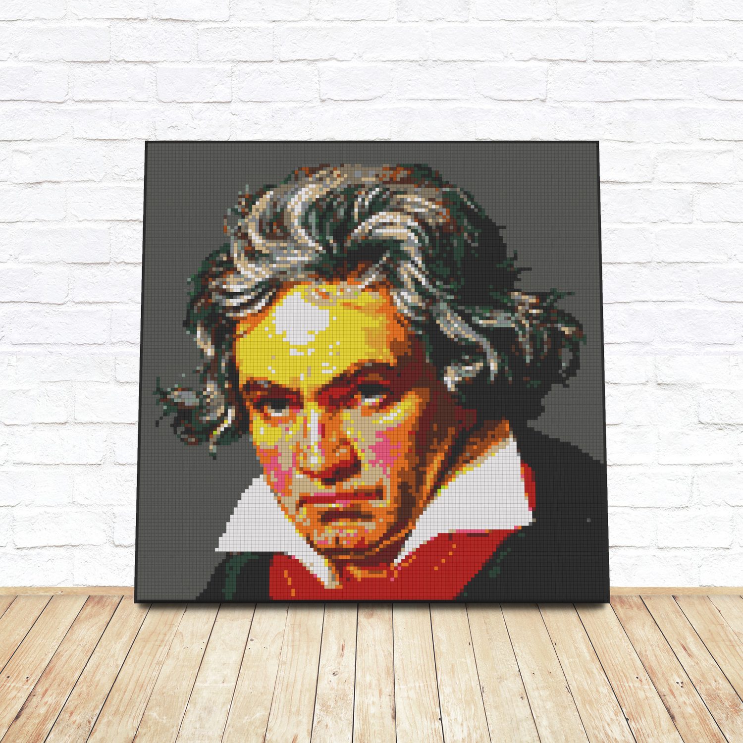 Framed LEGO tile pop-art portrait of Ludwig van Beethoven leaning against a white brick wall