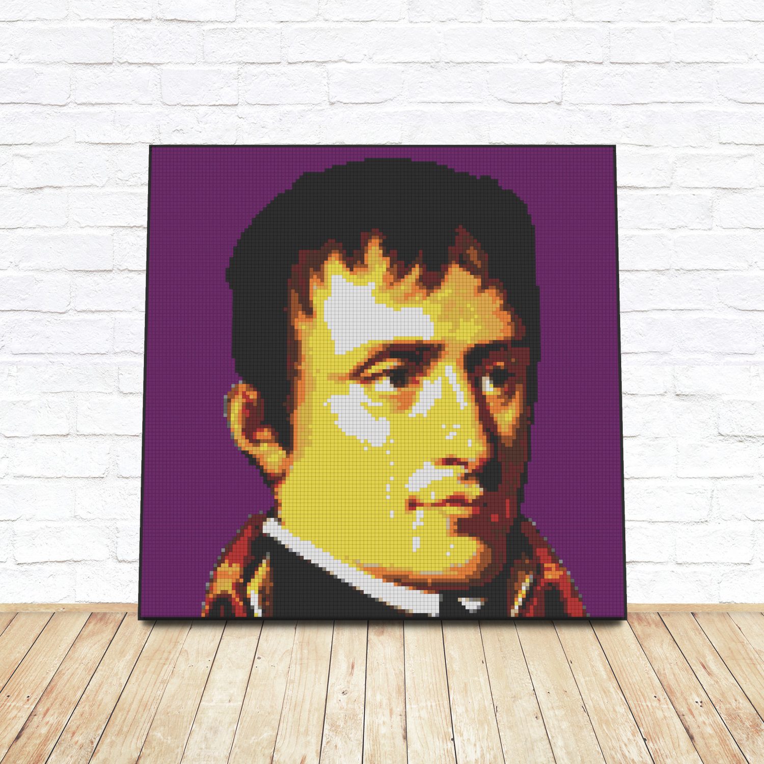 Framed LEGO tile pop-art portrait of Napoleon Bonaparte leaning against a white brick wall