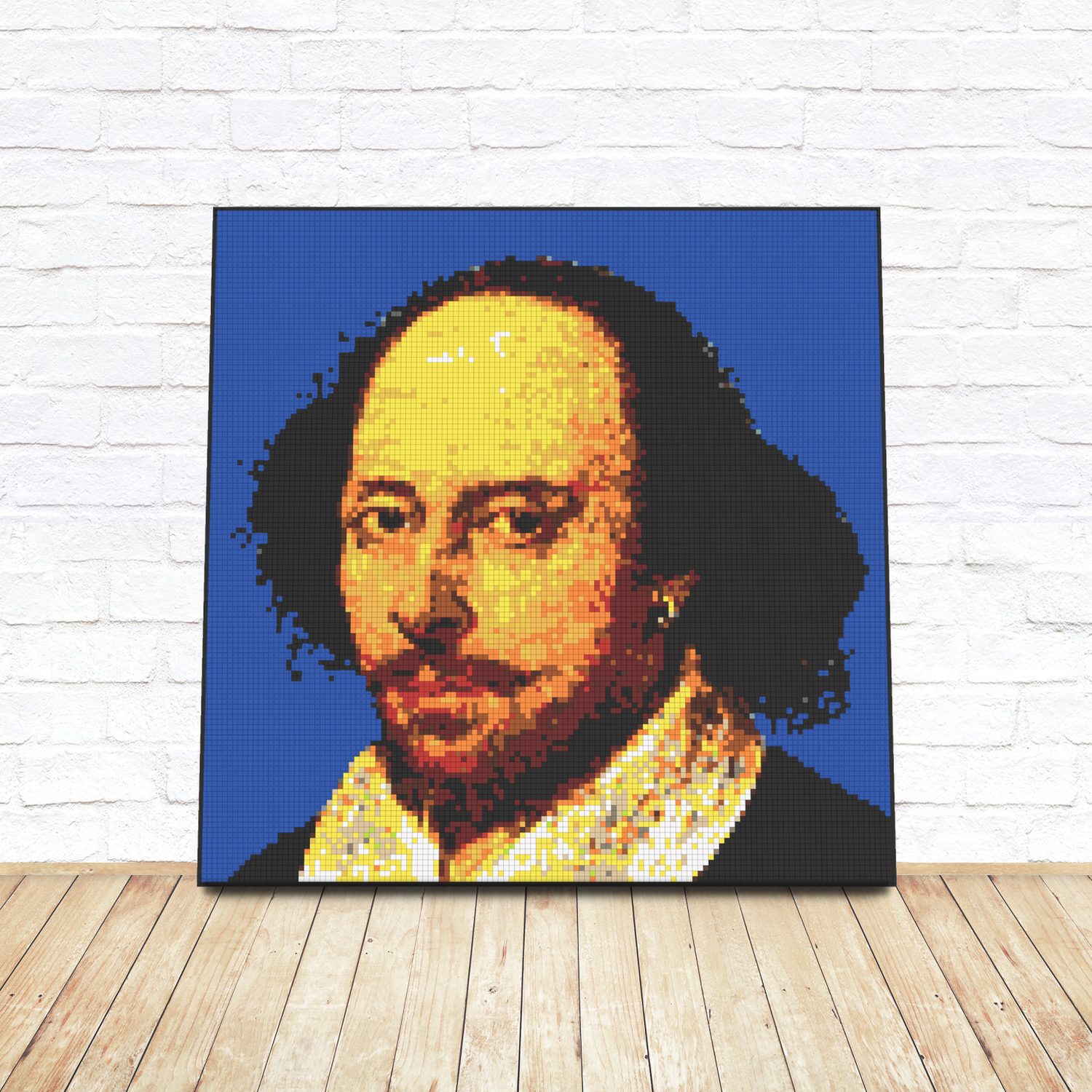 Framed LEGO tile pop-art portrait of William Shakespeare leaning against a white brick wall
